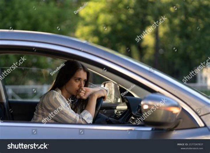 Is it safe to sit in a running car with the air conditioner on?