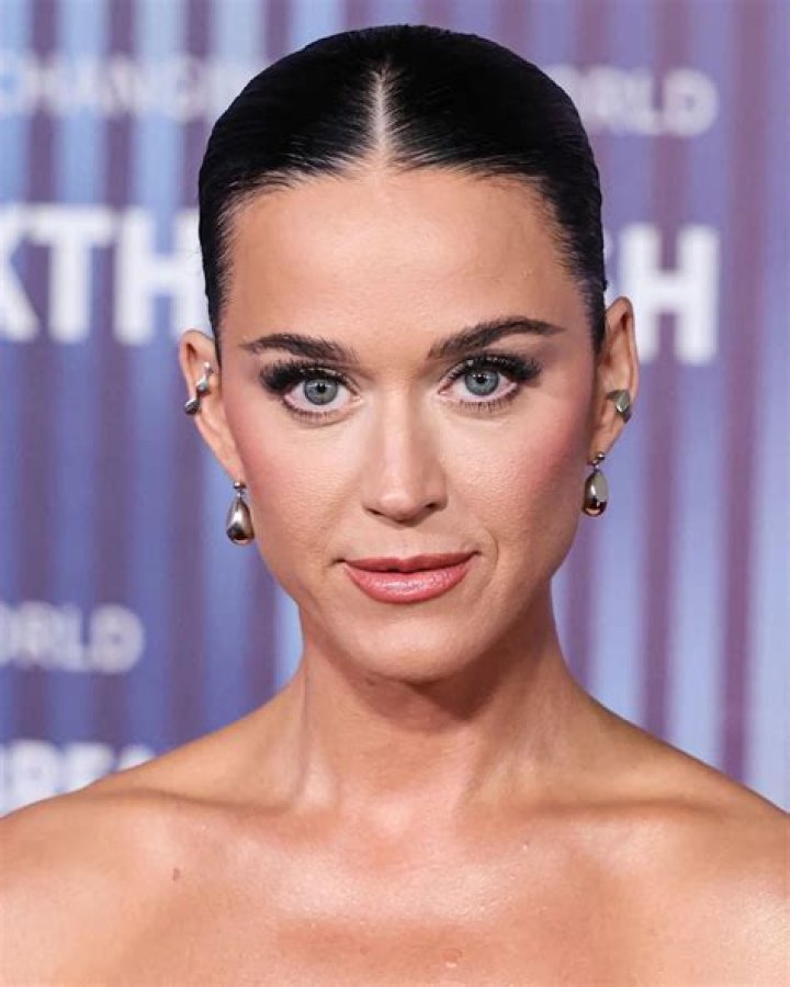 What does Katy Perry's bicep tattoo say?