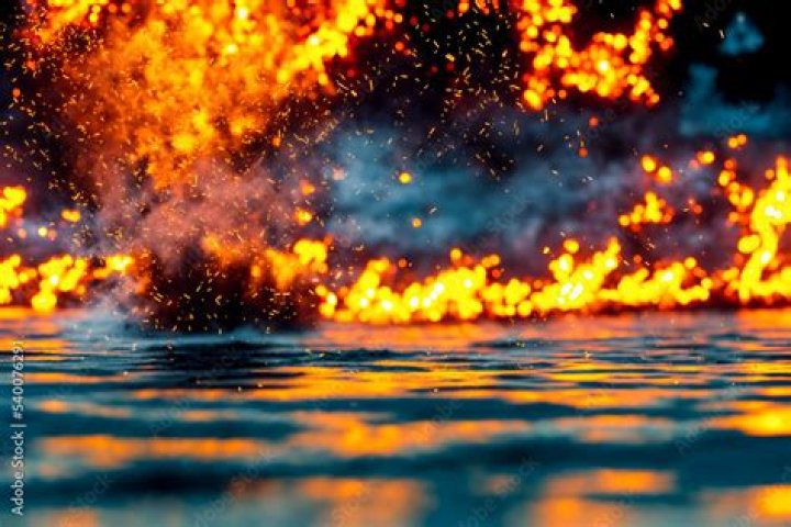 Why does hot oil catch fire with water?